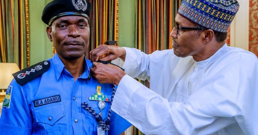 President Muhammadu Buhari decorates new IGP Mohammed Adamu