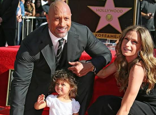 Dwayne "The Rock" Johnson, his wife and daughter